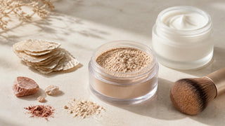 Loose mineral powder and a soft brush beside a jar of moisturizer for dry skin prep