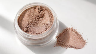 Satin mineral eyeshadow powder with a soft luminous finish on a neutral background