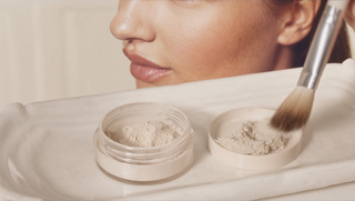 Applying mineral powder foundation with a soft kabuki brush