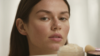 Gentle mineral powder makeup for sensitive skin on a soft neutral background