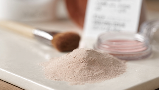 Talc-free mineral powder makeup on a clean neutral background